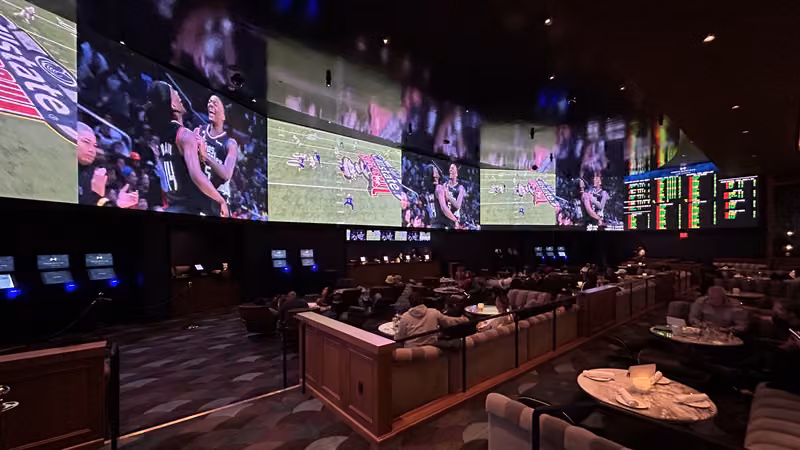 Wall-to-wall video screens and lounge seating in the sportsbook at Fontainebleau Las Vegas